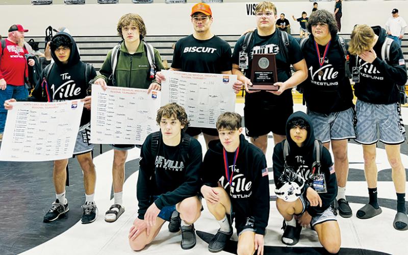 The Robbinsville Black Knights’ regional finalists display the 2023-24 1A Western  Regional Runner-Up plaque at the end of the two-day invitational. All names are listed from left. Kneeling in front: Lleyton Hooper, Skyler Anderson and Adair Panama. Back row: Alexis Panama, Loxston Hooper, Kage Williams, Koleson Dooley, Kellen Ensley and Avery Phillips. Photo by Audrey Colvin/The Graham Star