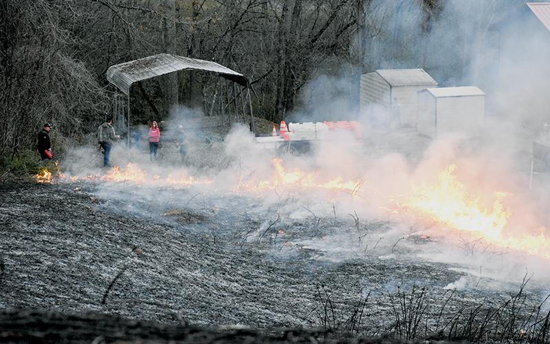 As part of a training exercise, the Graham County Fire Department conducted a controlled burn on a kudzu patch behind the EMS base off West Fort Hill on March 25. Though this fire was monitored from the get-go, brush fires being set across the county have proved difficult to maintain in recent weeks. Photo by Kevin Hensley/editor@grahamstar.com