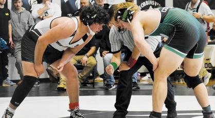 Robbinsville’s Kellen Ensley (215) stares down Mountain Heritage’s Braxton Batchelor at the dawn of overtime in the semifinals of Saturday’s James Orr Invitational. Ensley would soon take a 13-11 decision over Batchelor and was later named the Most Outstanding Boys Wrestler of the tournament. Photo by Audrey Colvin/The Graham Star