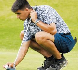 Black Knights junior Isaiah Brown lines up a putt on the 18th hole of Mountain  Harbour Golf Course on Monday. Brown went on to sink the ball for birdie and qualify for his second-straight trip to the state tournament. Photo by Kevin Hensley/sports@grahamstar.com